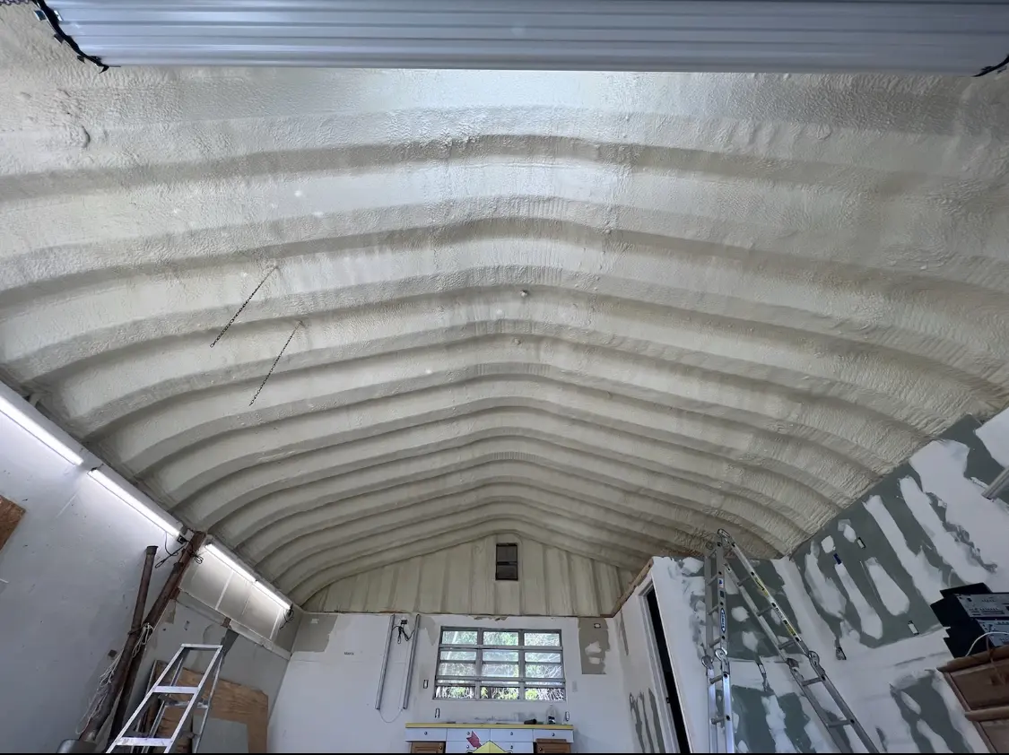 Spray polyurethane foam applied to the underside of a metal roof deck in Moreau